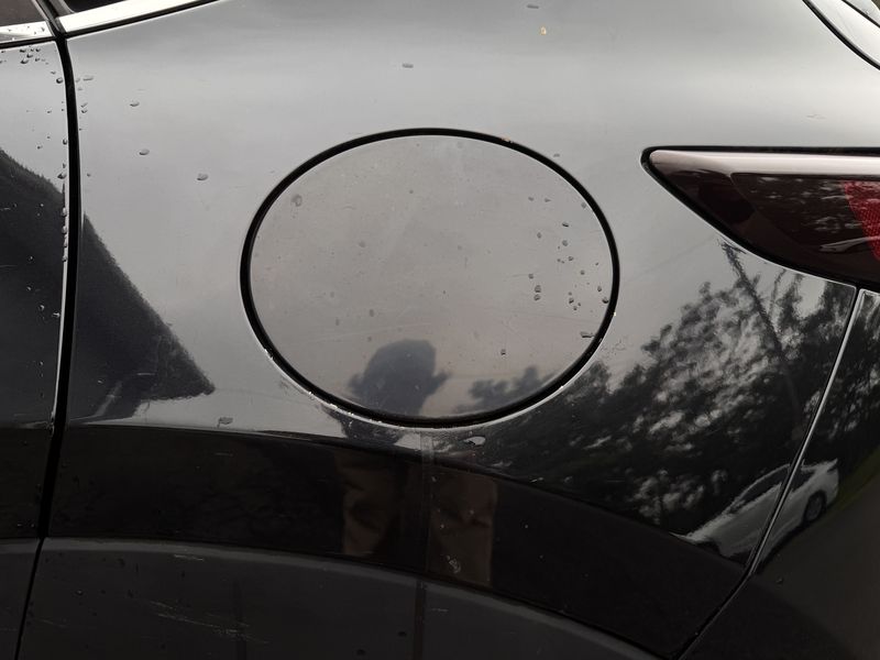 Fuel door before, with water spots.