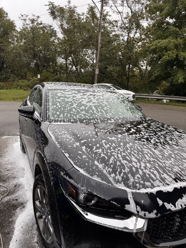 Foam pre-wash running down the car.
