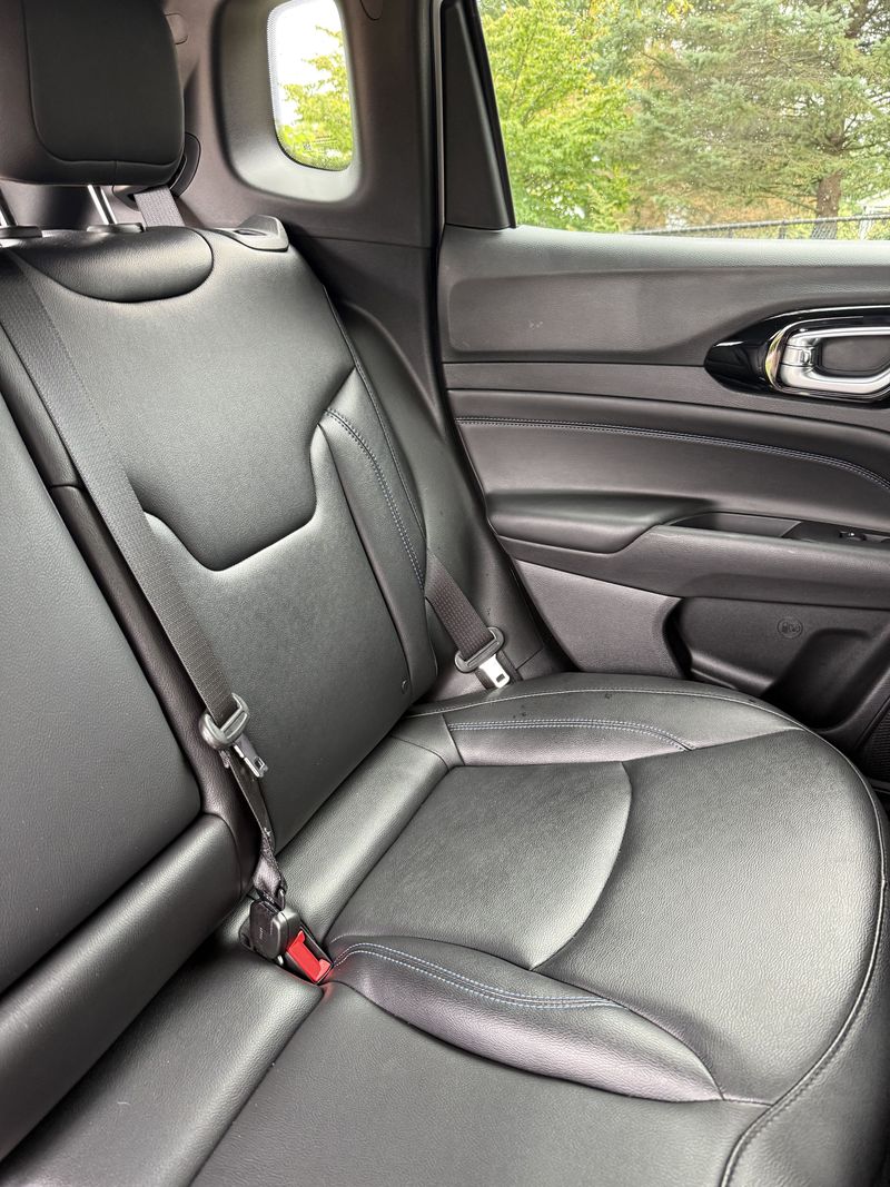Clean black leather rear seat in a Jeep Compass.
