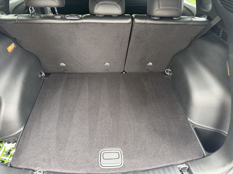 Clean, vacuumed cargo area of a Jeep Compass with the rear seats up.