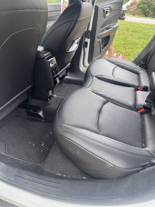 Rear seat and floor before, with debris.