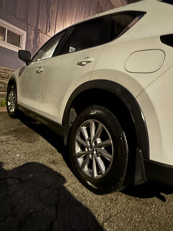 Rear wheel and quarter panel at night.